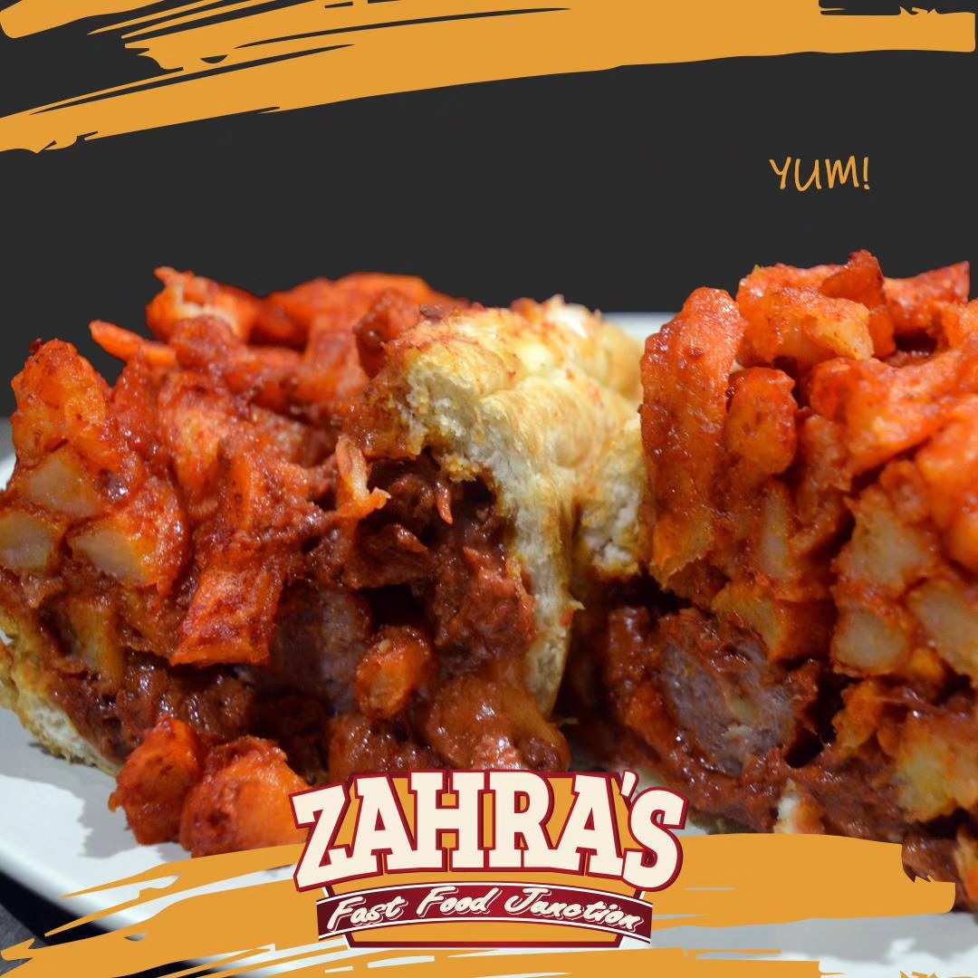 A loaded Zahra's bunny filled with chips and meat