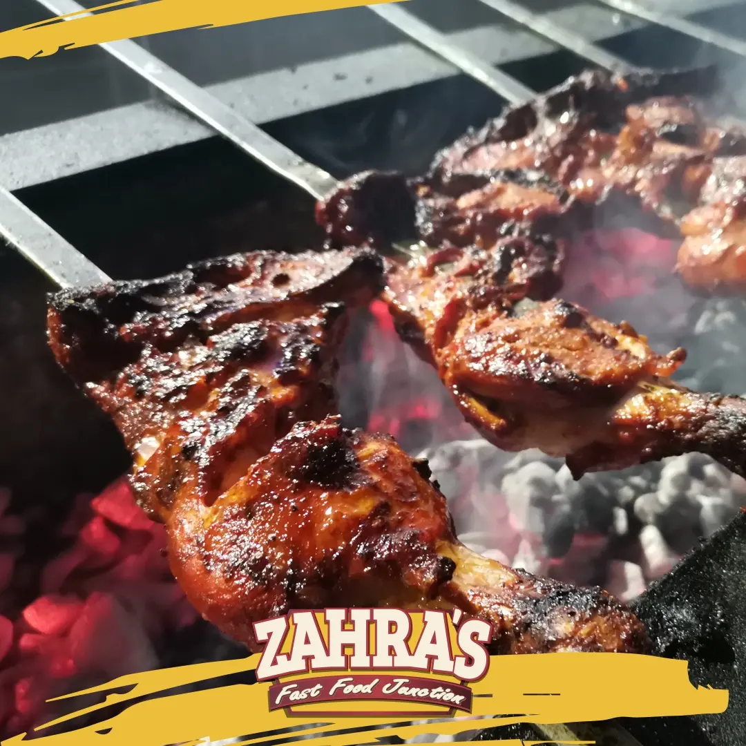 Zahra's chicken tikka grilling over hot coals